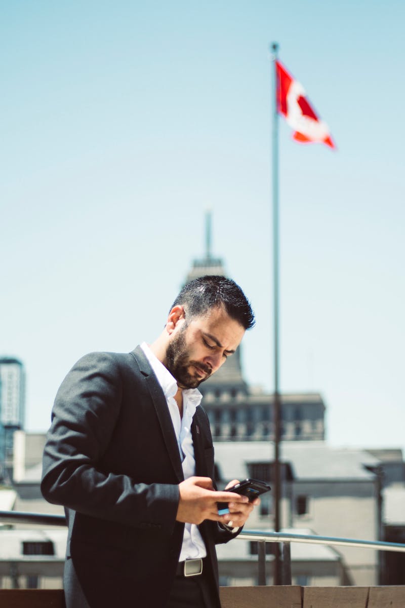 Man in Suit Jacket Holding Phone