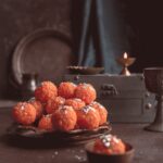 a plate of food sitting on a table next to a candle